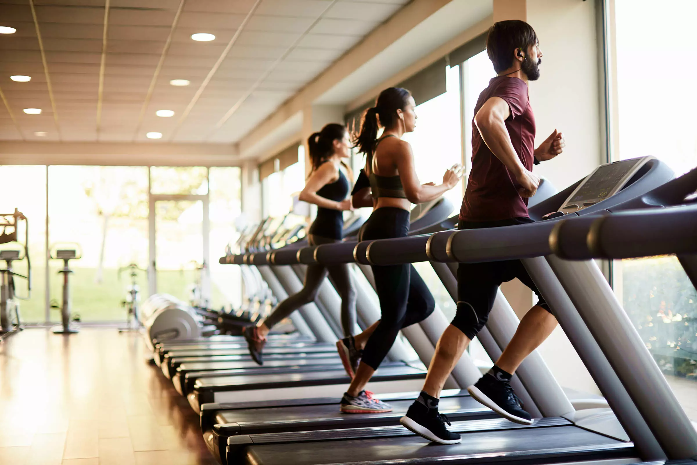 Group of people exercising on treadmills in a fitness center